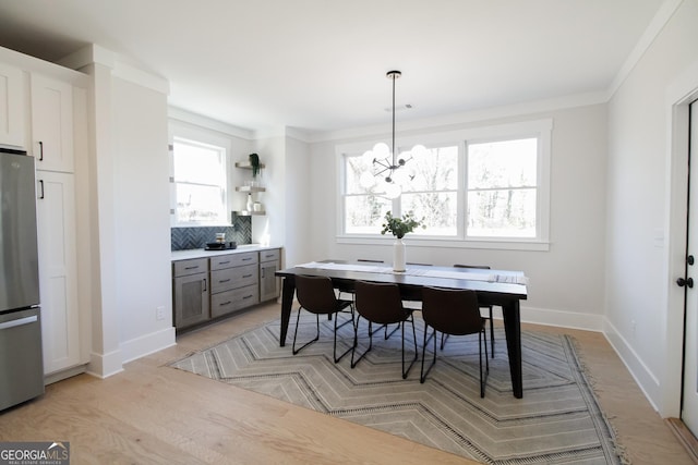 dining room featuring plenty of natural light and a notable chandelier