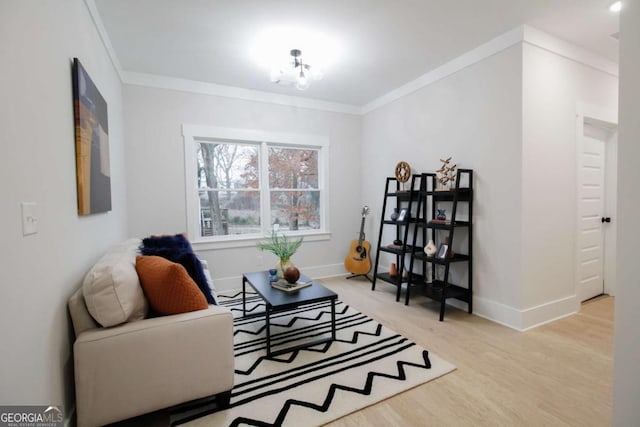 sitting room featuring crown molding and hardwood / wood-style floors