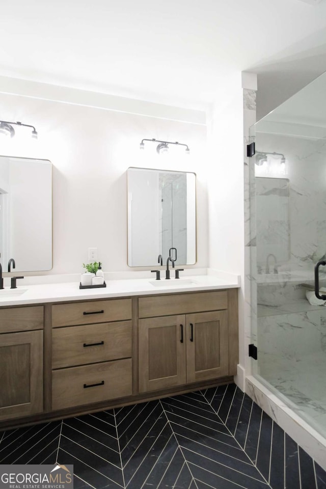 bathroom featuring an enclosed shower and vanity