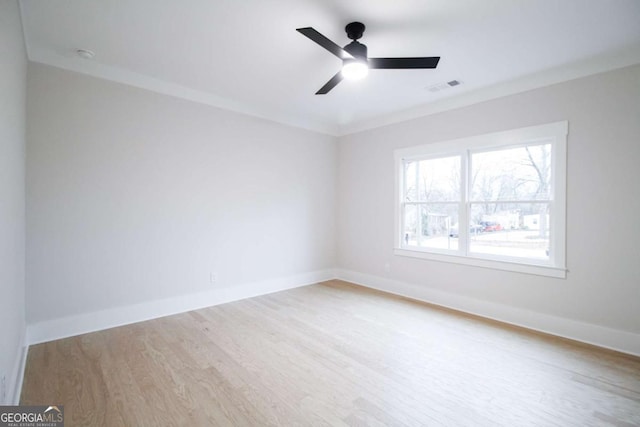 unfurnished room featuring crown molding, ceiling fan, and light hardwood / wood-style flooring