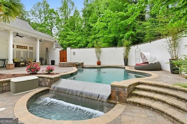 view of swimming pool with ceiling fan, a patio area, and pool water feature