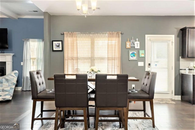 dining space featuring dark hardwood / wood-style floors and a notable chandelier