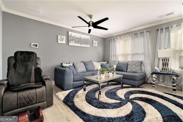 living room with hardwood / wood-style floors, ornamental molding, and ceiling fan