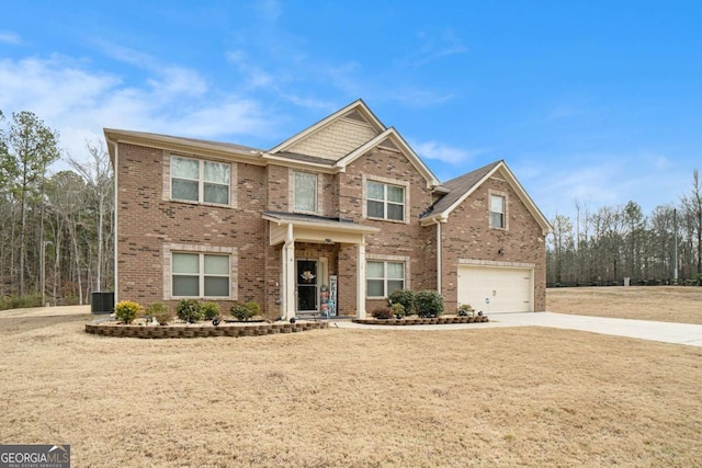 view of front facade with central AC unit, a garage, and a front yard