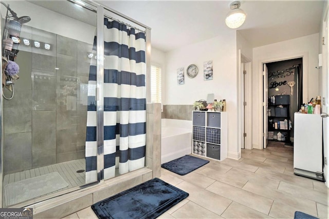 bathroom featuring separate shower and tub