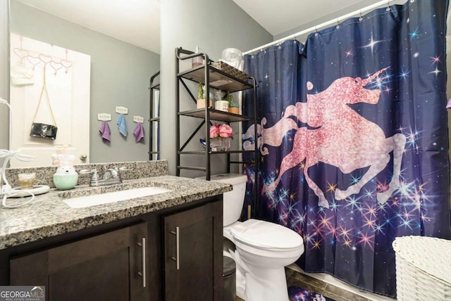 bathroom featuring vanity, a shower with shower curtain, and toilet