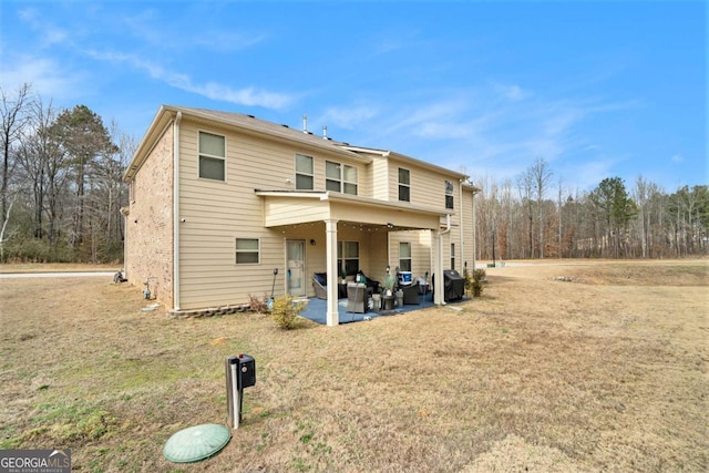 rear view of house with a yard and a patio