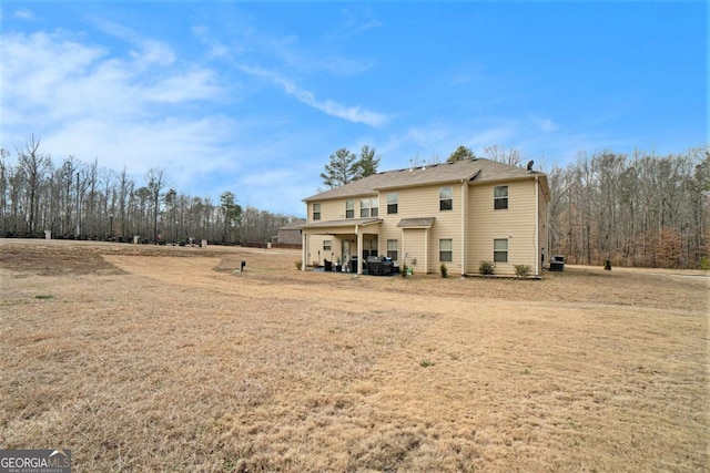 rear view of property with a yard