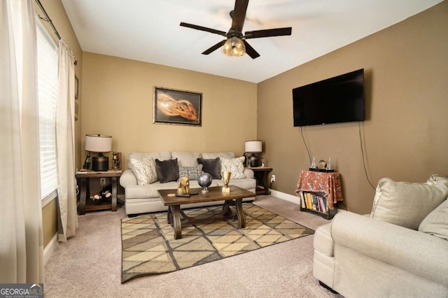 living room featuring light carpet and ceiling fan