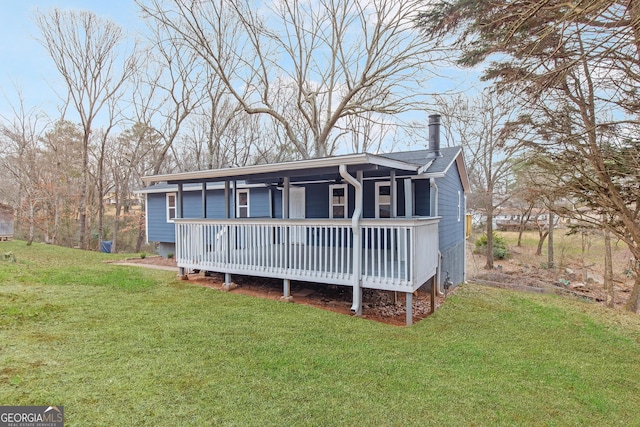 view of front of property with a wooden deck and a front yard