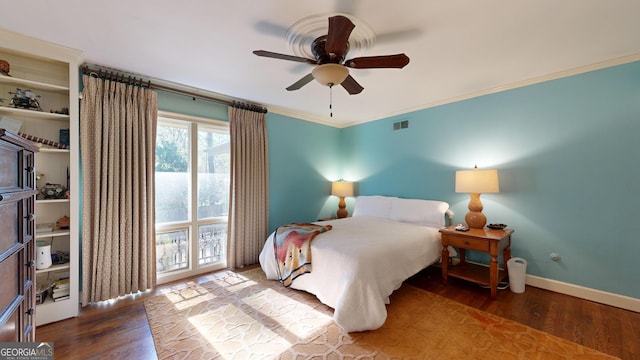 bedroom featuring ornamental molding, hardwood / wood-style floors, and ceiling fan