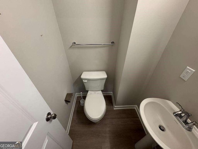 bathroom featuring hardwood / wood-style flooring, sink, and toilet