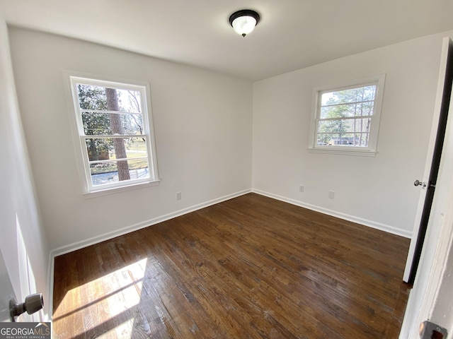 unfurnished room featuring dark wood-type flooring