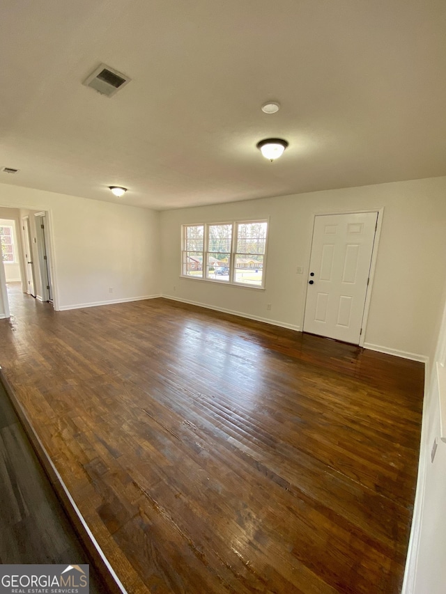 empty room with dark hardwood / wood-style floors