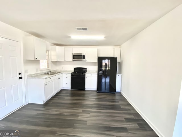 kitchen featuring white cabinetry, sink, dark wood-type flooring, and black appliances