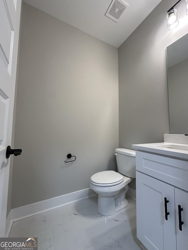 bathroom featuring double vanity, visible vents, marble finish floor, a shower stall, and a sink