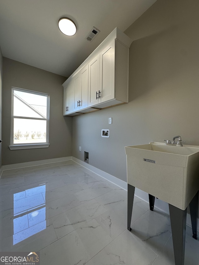 mudroom featuring baseboards, visible vents, and wood finished floors