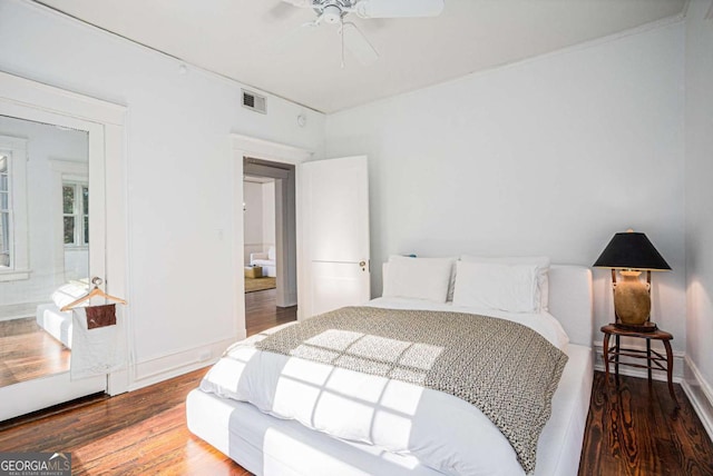 bedroom featuring hardwood / wood-style floors and ceiling fan