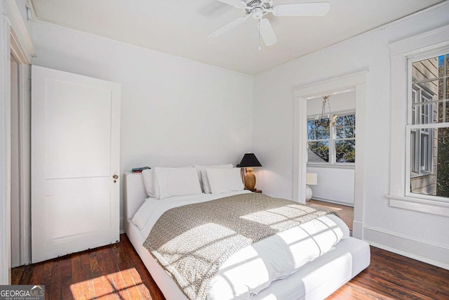 bedroom with dark hardwood / wood-style floors and ceiling fan