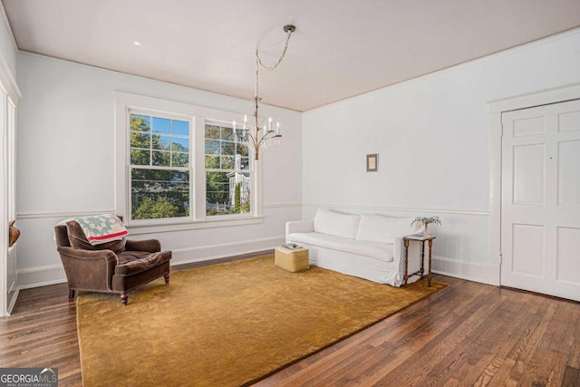 living area featuring dark hardwood / wood-style flooring and a notable chandelier