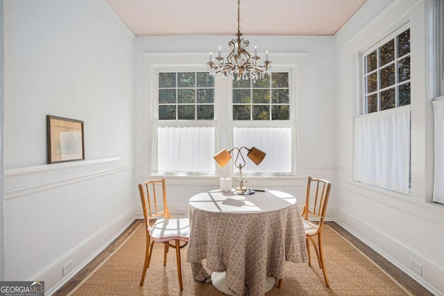 dining room featuring hardwood / wood-style flooring and a chandelier