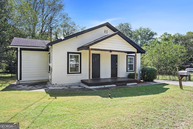 bungalow-style home with a porch and a front lawn