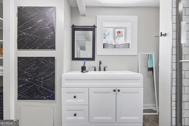 bathroom with marble finish floor and vanity