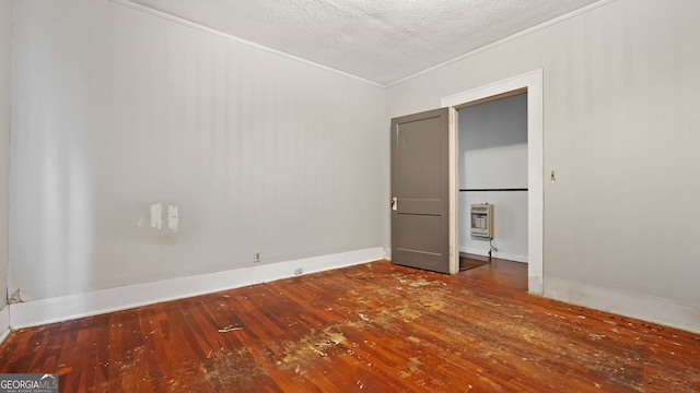 unfurnished bedroom featuring crown molding, wood-type flooring, heating unit, and a textured ceiling