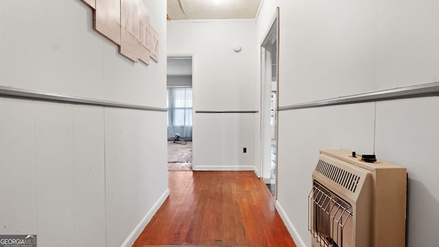 hall featuring heating unit and wood-type flooring