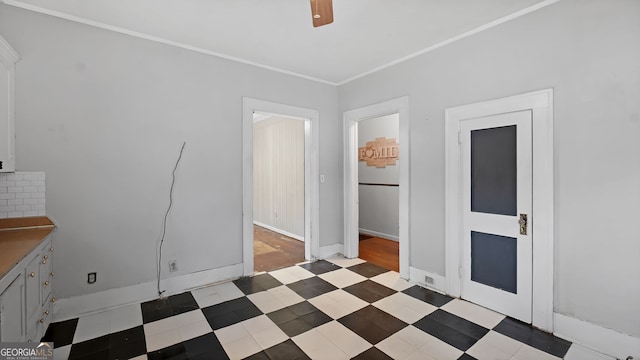 interior space featuring ornamental molding and ceiling fan