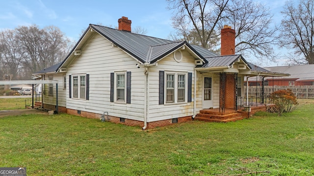 rear view of property featuring a yard