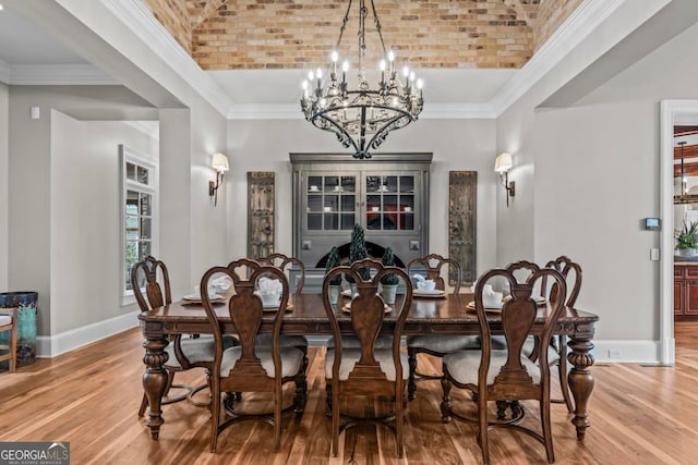 dining area featuring hardwood / wood-style flooring, brick ceiling, and crown molding