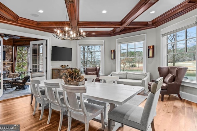 dining area with coffered ceiling, beam ceiling, light hardwood / wood-style flooring, and crown molding