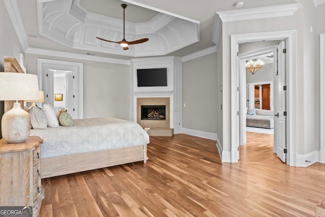 bedroom featuring coffered ceiling, crown molding, wood-type flooring, and a chandelier