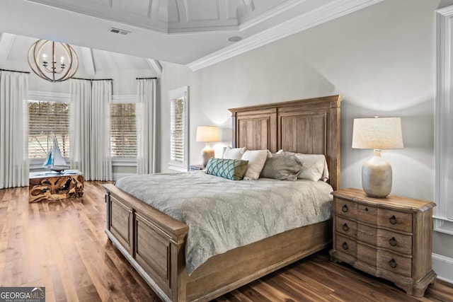 bedroom featuring crown molding, dark hardwood / wood-style flooring, and an inviting chandelier