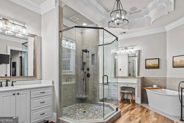 bathroom featuring crown molding, separate shower and tub, hardwood / wood-style floors, and vanity