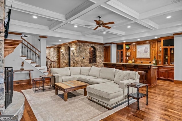 living room with coffered ceiling, beam ceiling, and light wood-type flooring