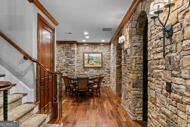 wine cellar featuring ornamental molding and dark hardwood / wood-style floors