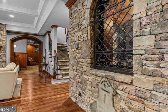 corridor featuring hardwood / wood-style flooring and ornamental molding