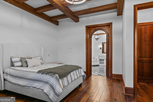 bedroom featuring ensuite bath, dark wood-type flooring, and beamed ceiling