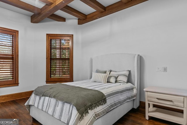 bedroom featuring dark wood-type flooring, multiple windows, and beamed ceiling