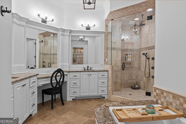 bathroom with ornamental molding, an enclosed shower, and vanity