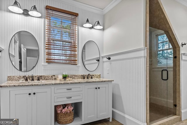 bathroom featuring vanity, ornamental molding, and walk in shower