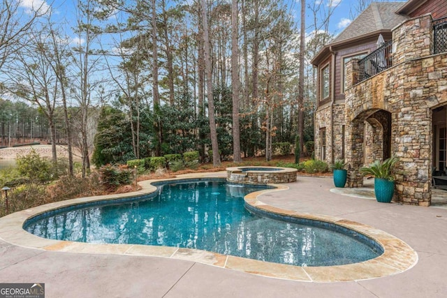 view of swimming pool with an in ground hot tub and a patio