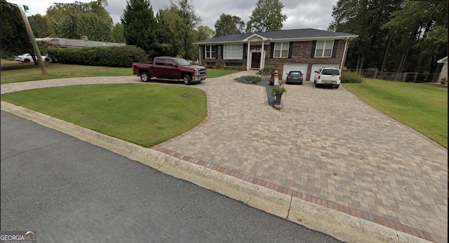 view of front of house featuring a garage and a front yard