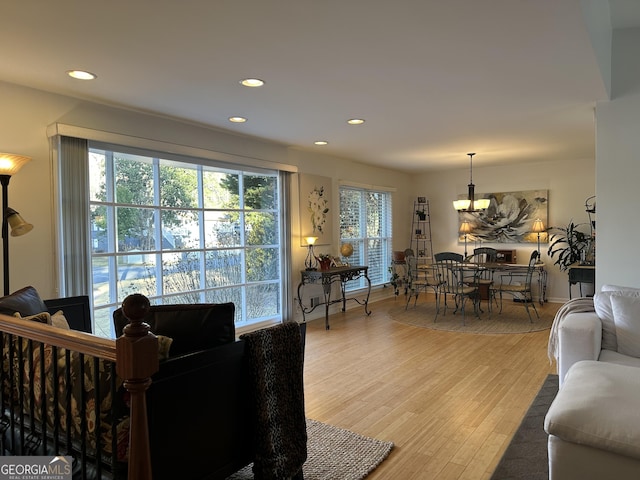 living room featuring wood-type flooring and a notable chandelier