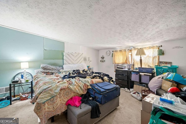 bedroom featuring light carpet and a textured ceiling