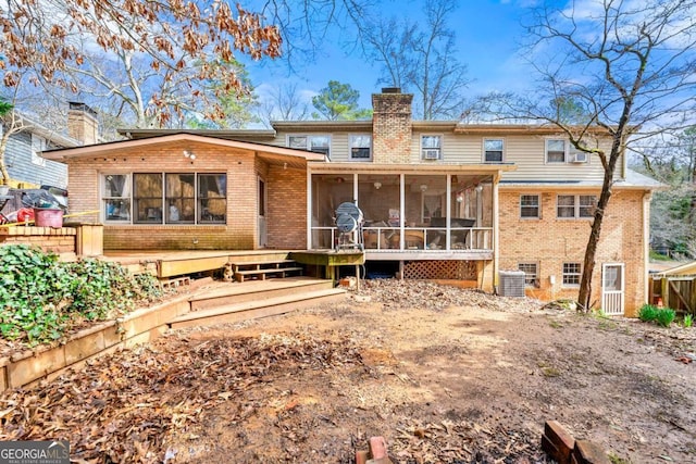 back of house featuring a sunroom and a deck