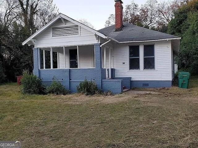 749 Grenada Ter, Macon, GA 31206 - bungalow-style house with a chimney, a front yard, crawl space, and roof with shingles