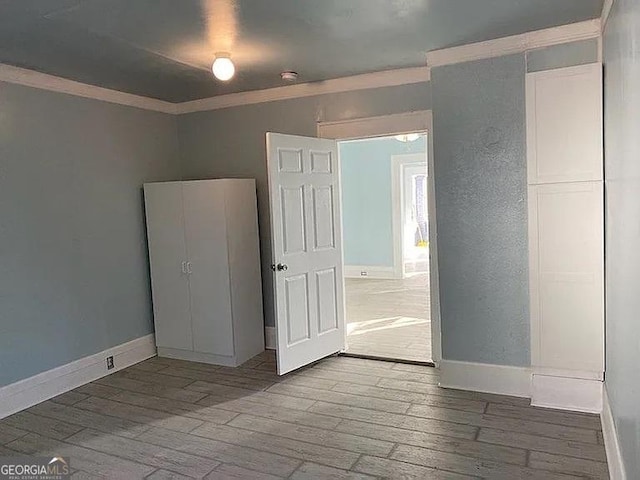 749 Grenada Ter, Macon, GA 31206 - unfurnished bedroom with hardwood / wood-style flooring and crown molding